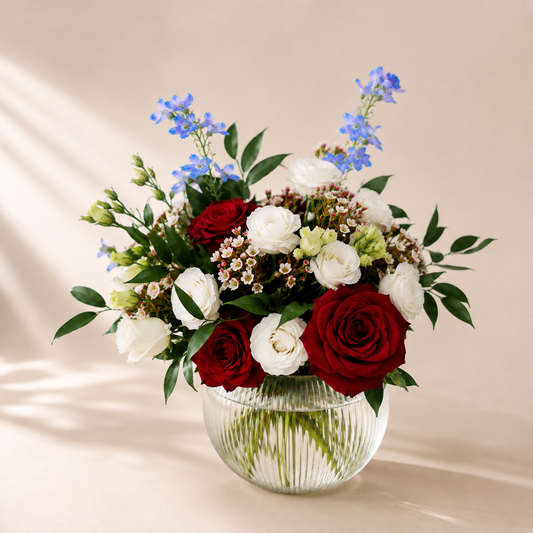 Elegant floral centerpiece with blue delphiniums available for flower delivery in Toronto and Mississauga.
