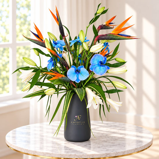Blue orchid arrangement with Bird of Paradise and white lilies by Amarilis Flowers