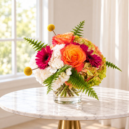 Bright mixed flower arrangement in a glass vase for centerpiece flower delivery Toronto