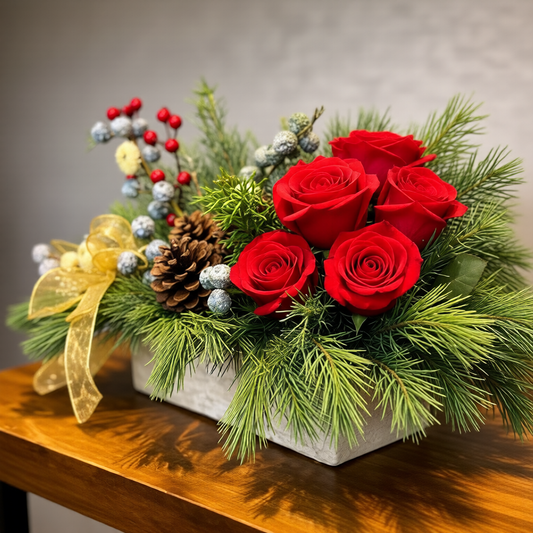 Christmas floral centerpiece with red roses and seasonal greenery