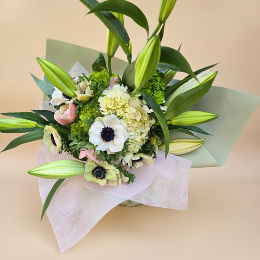 Close-up of white flowers and green foliage in floral arrangement