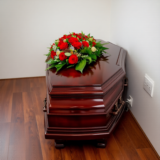 Elegant funeral casket spray with red roses for memorial services in Toronto