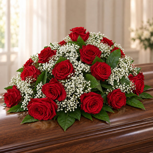 Red rose memorial casket flowers with white gypsophila and green foliage