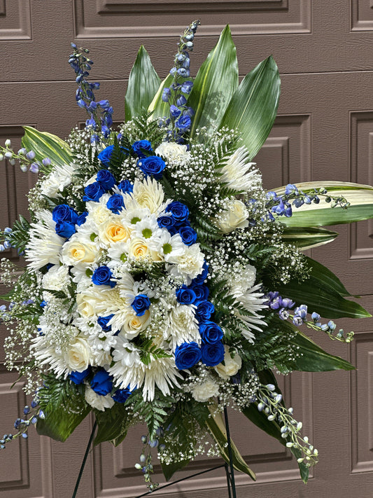 Standing memorial spray with white and blue flowers