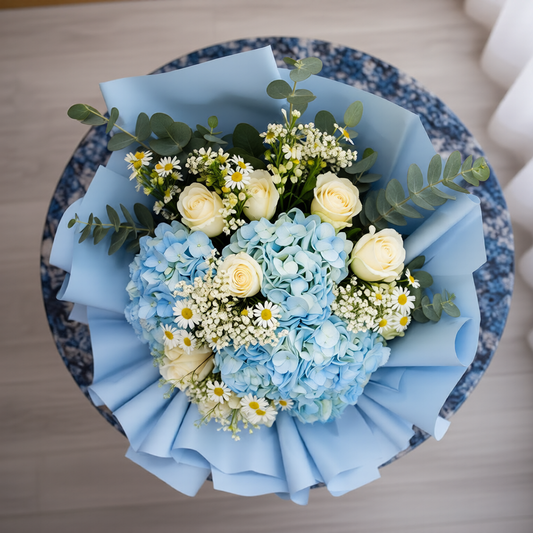 Blue and white floral arrangement with soft textures
