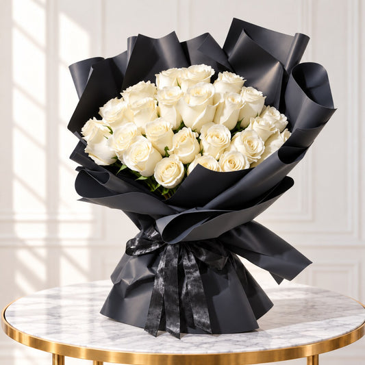 Right-side view of a white rose arrangement in sculptural black wrapping