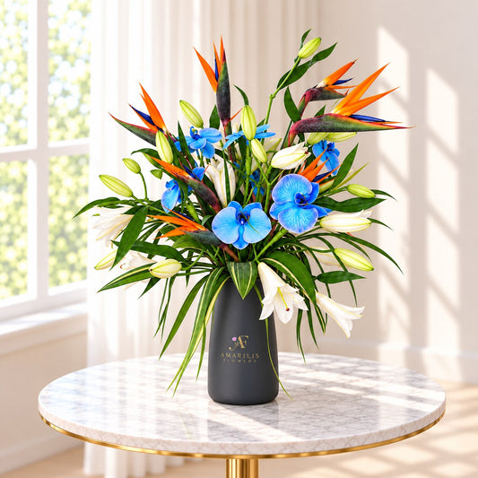 Top angle view of Bird of Paradise flowers with blue orchids and tropical greenery