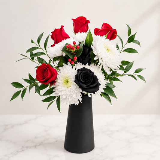 Black rose flower arrangement with red roses and white chrysanthemums in a modern black vase