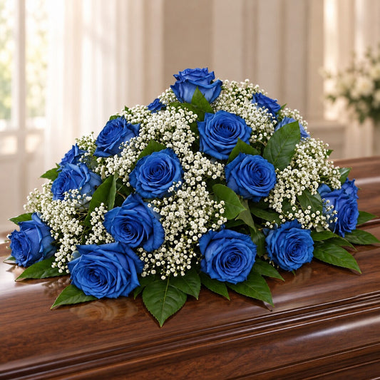 Blue rose casket spray with white baby’s breath for Toronto funeral delivery