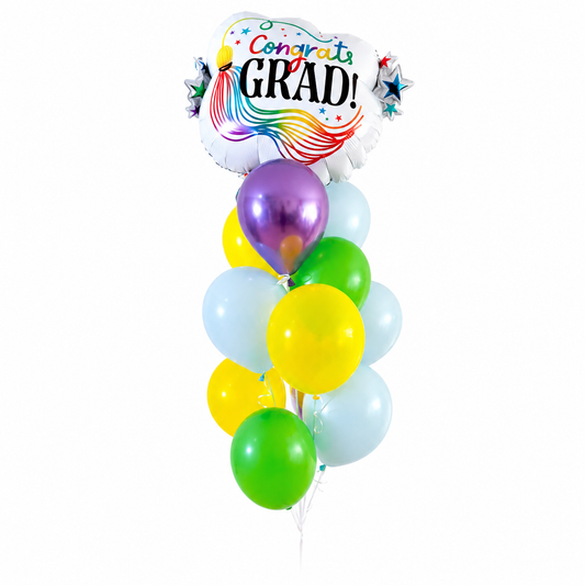Full view of a graduation balloon arrangement with multicolour balloons, trailing ribbons and a weight against a white background.
