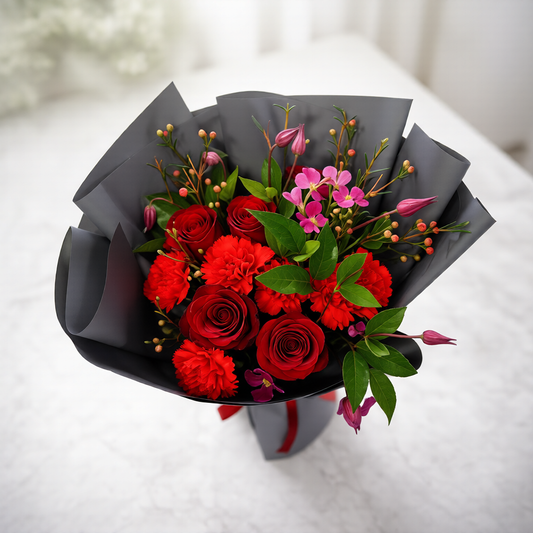 Handcrafted red floral bouquet designed by Toronto florist