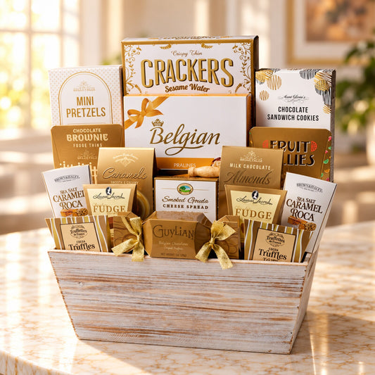 Gourmet gift basket Toronto with Belgian chocolates, crackers, pretzels, caramel, almonds and savoury treats in a white wooden basket. 