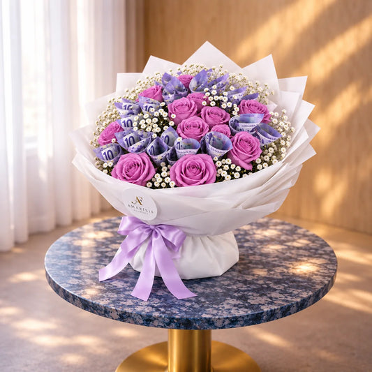 Side view of Lavender Fortune with layered white wrapping and a lavender satin bow on a marble table.
