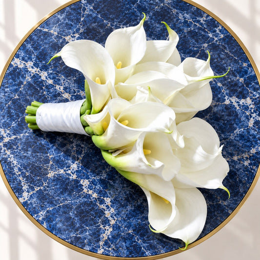 	Side view of a cascading white bridal bouquet on a blue marble table