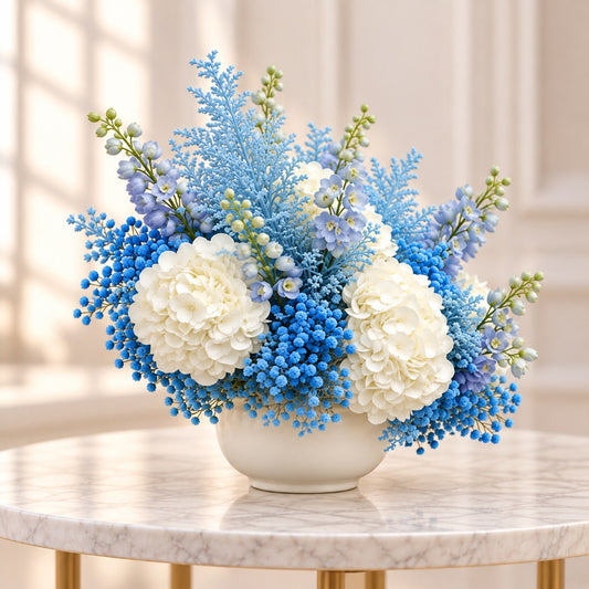 New baby boy flowers with white hydrangeas and delicate blue blooms in an ivory vessel