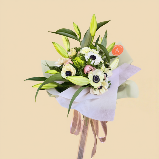Elegant white flower arrangement with fresh green foliage