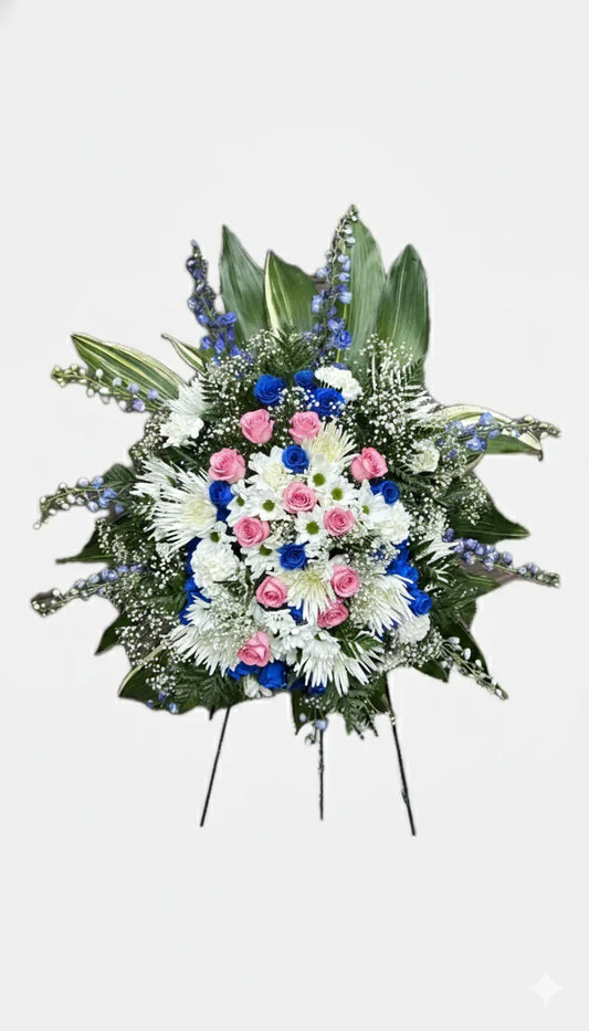 Memorial flower arrangement displayed on an easel

