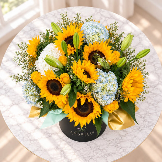 Top view of Sunlit Garden with yellow sunflowers, blue hydrangeas, lily buds and seasonal greenery