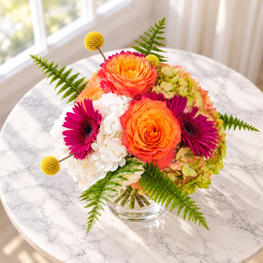 Top view of Sunset Bliss with roses, gerberas, hydrangeas and fresh fern leaves