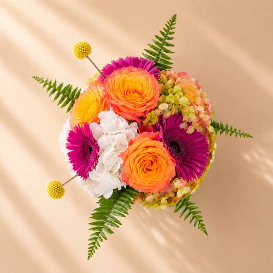 Sunset Bliss colorful floral centerpiece handcrafted with fresh flowers for same-day delivery in Toronto.