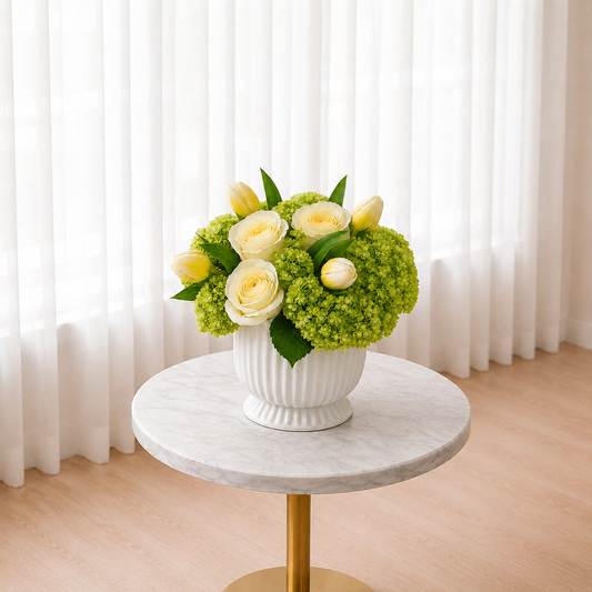 Wide side view of white rose centerpiece on a marble table for flower delivery in Mississauga