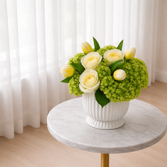 Side view of Citrus & Cream floral centerpiece with white roses and green hydrangeas