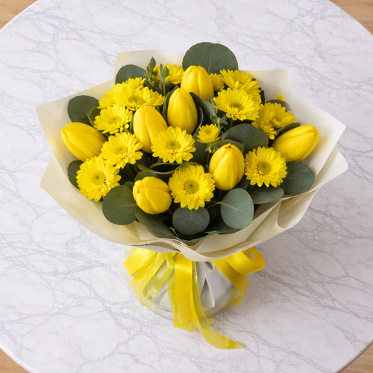 Sunlit Zest yellow bouquet same day flower delivery Toronto top view marble table